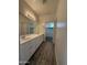 Modern bathroom with double sinks, a large mirror, and wood-look tile flooring at 1730 W Pollack St, Phoenix, AZ 85041