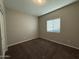 A cozy bedroom with a large window allowing natural light to illuminate the neutral walls and plush carpeting at 1730 W Pollack St, Phoenix, AZ 85041