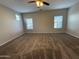 Spacious bedroom with neutral walls, carpet flooring, and a ceiling fan for comfortable living at 1730 W Pollack St, Phoenix, AZ 85041
