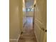 Hallway with wood-look tile flooring leading to a bedroom with natural light and a ceiling fan at 1730 W Pollack St, Phoenix, AZ 85041