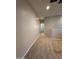 Hallway featuring carpet flooring, neutral wall color and a doorway leading to a different space at 1730 W Pollack St, Phoenix, AZ 85041