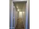 Hallway with wood-look tile flooring, bright white walls, and white doors at 1730 W Pollack St, Phoenix, AZ 85041