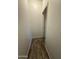 Narrow hallway with wood-look tile flooring, bright white walls, and white doors at 1730 W Pollack St, Phoenix, AZ 85041