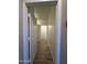 Hallway with wood-look tile flooring, bright white walls, and white doors at 1730 W Pollack St, Phoenix, AZ 85041