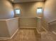 Upstairs hallway with plush carpet, neutral colored walls and two windows at 1730 W Pollack St, Phoenix, AZ 85041