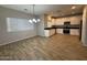 Spacious kitchen featuring wood tile floors, a dining area and modern appliances at 1730 W Pollack St, Phoenix, AZ 85041