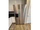 Stainless steel refrigerator with water and ice dispenser in a kitchen with white cabinets and granite countertops at 1730 W Pollack St, Phoenix, AZ 85041