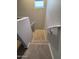 A carpeted staircase with handrails guides you downwards, blending safety with a modern design aesthetic at 1730 W Pollack St, Phoenix, AZ 85041