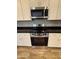 The stainless steel stove and microwave enhance the kitchen's modern aesthetic at 1730 W Pollack St, Phoenix, AZ 85041