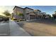 Exterior shot of modern homes with attached garages and desert landscaping along a quiet street at 1730 W Pollack St, Phoenix, AZ 85041