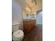 Well-lit bathroom featuring dual sinks, granite counters, and modern fixtures at 1738 W Pollack St, Phoenix, AZ 85041