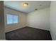 This is a bedroom with carpet floors, a window, and a simple ceiling light at 1738 W Pollack St, Phoenix, AZ 85041