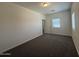 This carpeted bedroom provides a window, closet, and neutral palette creating a serene space at 1738 W Pollack St, Phoenix, AZ 85041