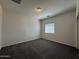 This is a bedroom with carpet floors, a window, and a simple ceiling light at 1738 W Pollack St, Phoenix, AZ 85041
