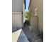 Exterior view of a home showing the side yard with rocks and utility features at 1738 W Pollack St, Phoenix, AZ 85041