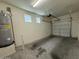 Functional garage with storage, water heater, lighting and two windows that provide natural light at 1738 W Pollack St, Phoenix, AZ 85041