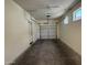 Functional garage showcasing the door mechanism, side door entrance and ample space for parking or projects at 1738 W Pollack St, Phoenix, AZ 85041
