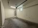 A spacious garage showcasing an efficient layout, a water heater, and two small windows for added natural light at 1738 W Pollack St, Phoenix, AZ 85041