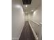 Bright hallway with neutral walls and carpet, featuring a white railing at 1738 W Pollack St, Phoenix, AZ 85041
