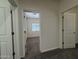 Hallway view showing access to bedroom with carpet flooring and white doors that create a seamless transition at 1738 W Pollack St, Phoenix, AZ 85041