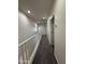 Bright hallway with neutral walls and carpet, featuring a white railing at 1738 W Pollack St, Phoenix, AZ 85041