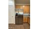 Stainless steel refrigerator complemented by granite countertops and wood cabinetry at 1738 W Pollack St, Phoenix, AZ 85041