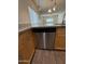 Kitchen featuring a granite countertop, stainless steel dishwasher, and wood cabinets at 1738 W Pollack St, Phoenix, AZ 85041