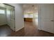 Open-concept living area with wood floors, modern lighting, and a view into the kitchen and dining space at 1738 W Pollack St, Phoenix, AZ 85041