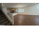Spacious, open-concept living room with wood-look tile floors, staircase, and window at 1738 W Pollack St, Phoenix, AZ 85041
