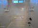 Bright shower with white tile and built-in shelving at 1738 W Pollack St, Phoenix, AZ 85041