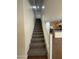 Carpeted stairway leading to the upper level with white railing, connecting the living space at 1738 W Pollack St, Phoenix, AZ 85041