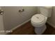 Powder room features wood floors, toilet, and silver accents creating a clean simple look at 1738 W Pollack St, Phoenix, AZ 85041
