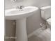 Bathroom features a pedestal sink and a modern toilet at 17615 W Palo Verde Dr, Litchfield Park, AZ 85340