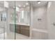 Bathroom featuring double sinks, and a spacious tiled shower with a small bench seat at 17615 W Palo Verde Dr, Litchfield Park, AZ 85340