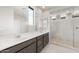 Modern bathroom featuring a double sink vanity and tiled shower at 17615 W Palo Verde Dr, Litchfield Park, AZ 85340