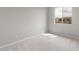 Bright bedroom with soft carpet and a large window at 17615 W Palo Verde Dr, Litchfield Park, AZ 85340