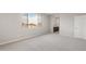 Carpeted bedroom with natural light and an open en-suite bathroom at 17615 W Palo Verde Dr, Litchfield Park, AZ 85340