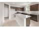 Bright kitchen with an island, stainless steel appliances, and tile flooring at 17615 W Palo Verde Dr, Litchfield Park, AZ 85340