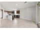 Open-concept kitchen features dark cabinets, stainless appliances, and an island at 17615 W Palo Verde Dr, Litchfield Park, AZ 85340