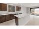 Kitchen with a center island, granite countertops, stainless steel appliances, and dark cabinetry at 17615 W Palo Verde Dr, Litchfield Park, AZ 85340