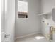 Well-lit laundry room with a window and shelf at 17615 W Palo Verde Dr, Litchfield Park, AZ 85340