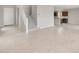 Open-concept living room with tile flooring, a staircase, and views into the kitchen at 17615 W Palo Verde Dr, Litchfield Park, AZ 85340