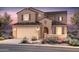 Charming two-story home boasts a desert landscape, tile roof, and attached two-car garage at 17620 W Pasadena Ave, Litchfield Park, AZ 85340