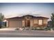Charming single-story home boasts desert landscaping, a two-car garage, and a welcoming entryway at 17674 W Palo Verde Dr, Litchfield Park, AZ 85340