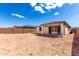 Wide backyard with covered patio, enclosed by a block wall offers potential for various outdoor activities and landscaping at 18486 E Dario Rd, Gold Canyon, AZ 85118