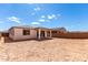 Spacious backyard features a covered patio and block fence, ready for landscaping and outdoor enjoyment at 18486 E Dario Rd, Gold Canyon, AZ 85118