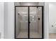 Bright bathroom shower showcasing glass doors, white tile, and matte black fixtures at 18486 E Dario Rd, Gold Canyon, AZ 85118