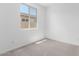 Bright bedroom with a large window, neutral carpet, and a view of the neighborhood at 18486 E Dario Rd, Gold Canyon, AZ 85118