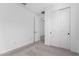 A clean bedroom featuring carpet flooring, closet and a door leading to more rooms at 18486 E Dario Rd, Gold Canyon, AZ 85118