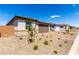 Beautifully landscaped front yard featuring stone accents and a driveway leading to a brown garage door at 18486 E Dario Rd, Gold Canyon, AZ 85118